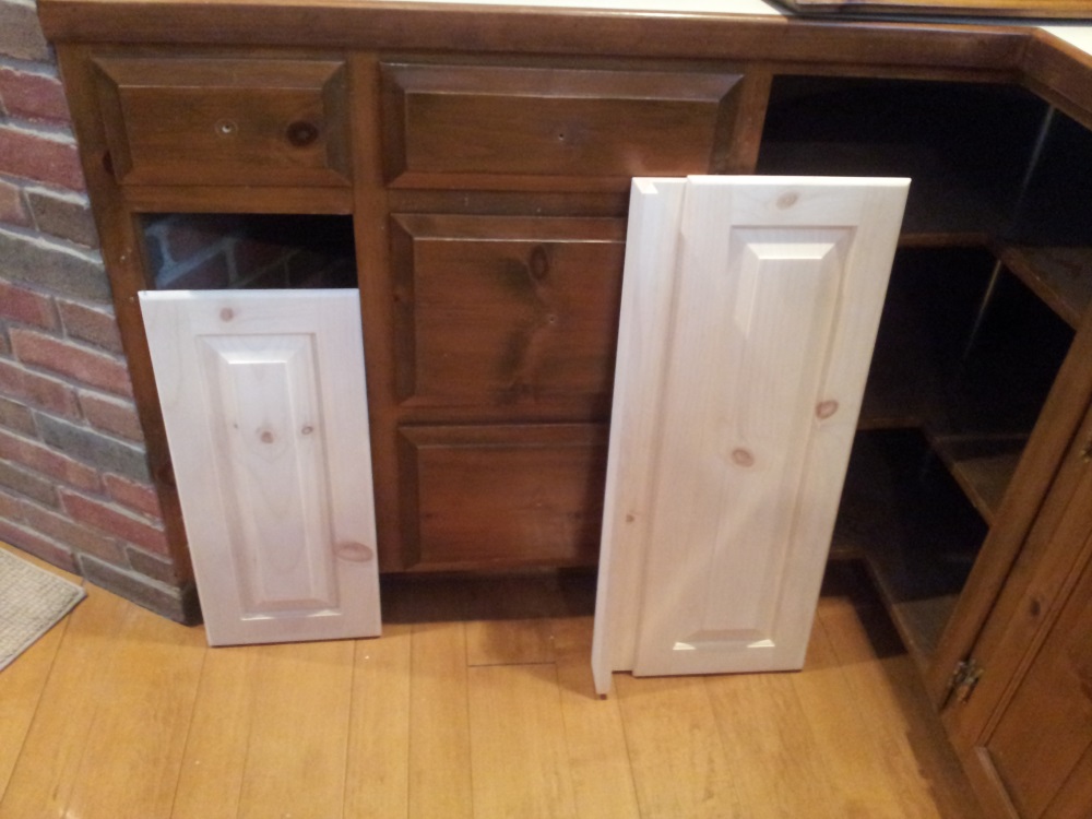 Replacement pine doors for damaged kitchen cabinets.